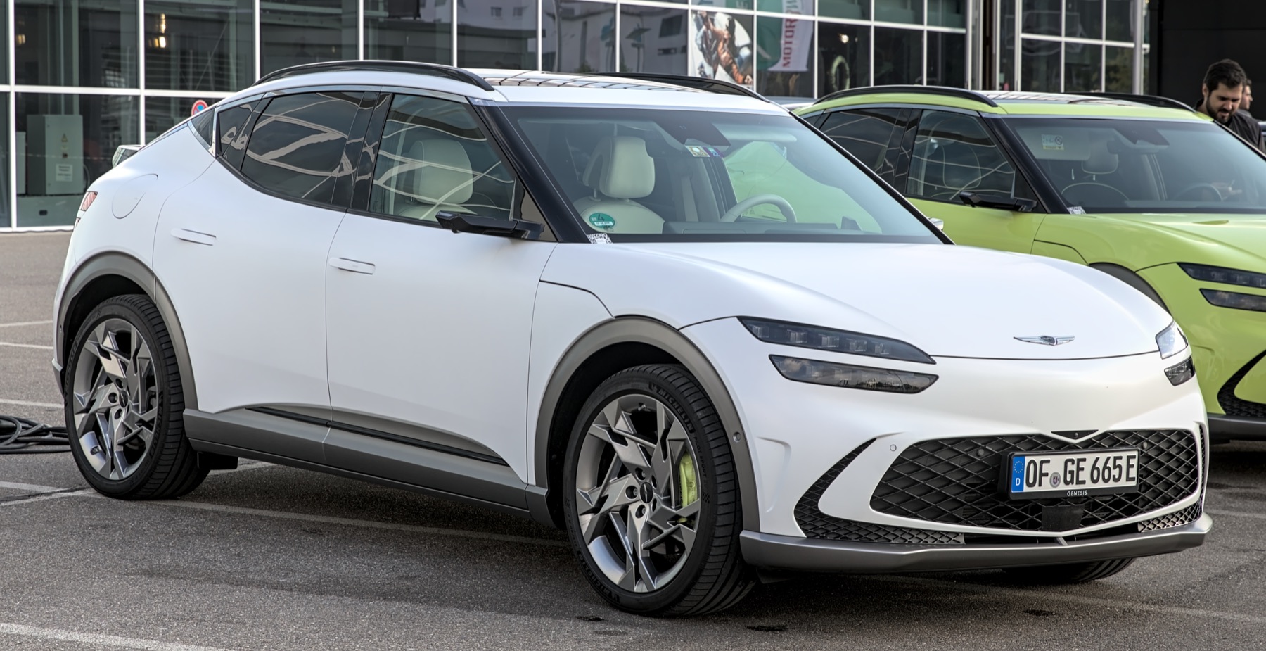 Genesis GV60 front three-quarter view in white, real-world photography.