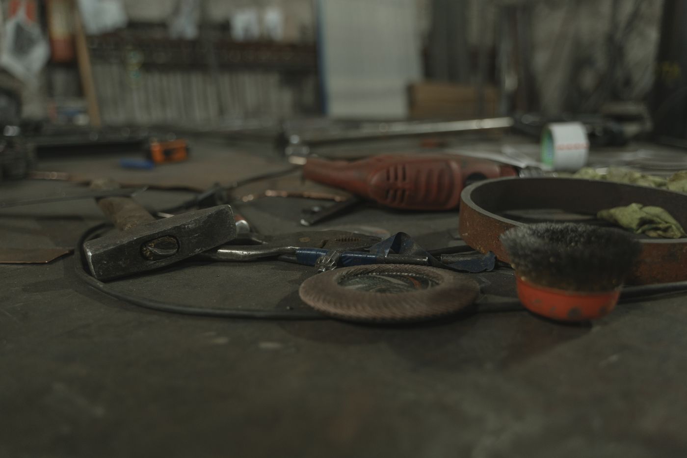 Hand tools resting on a dim workshop bench