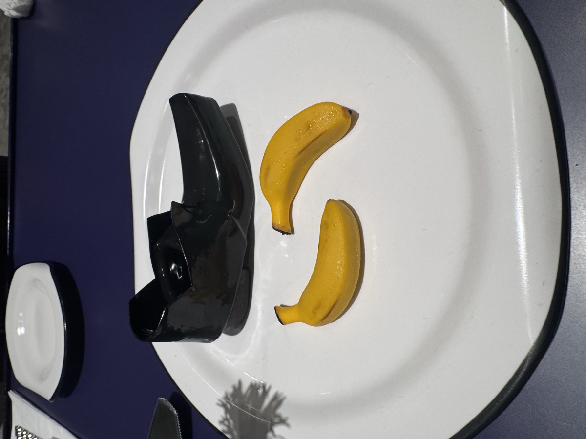 A dessert shaped like a black loafer, served with two candied bananas, at NUDAKE Teahouse.
