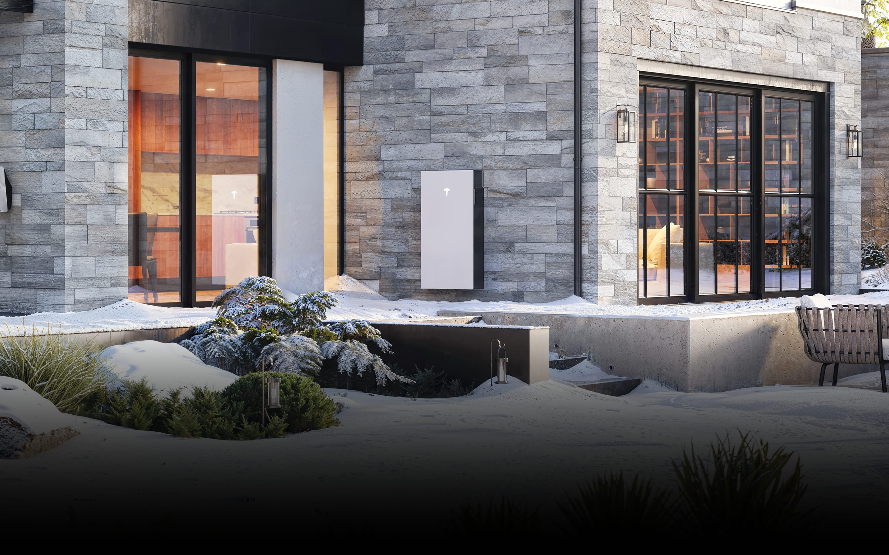Tesla Powerwall mounted on the exterior wall of a home.