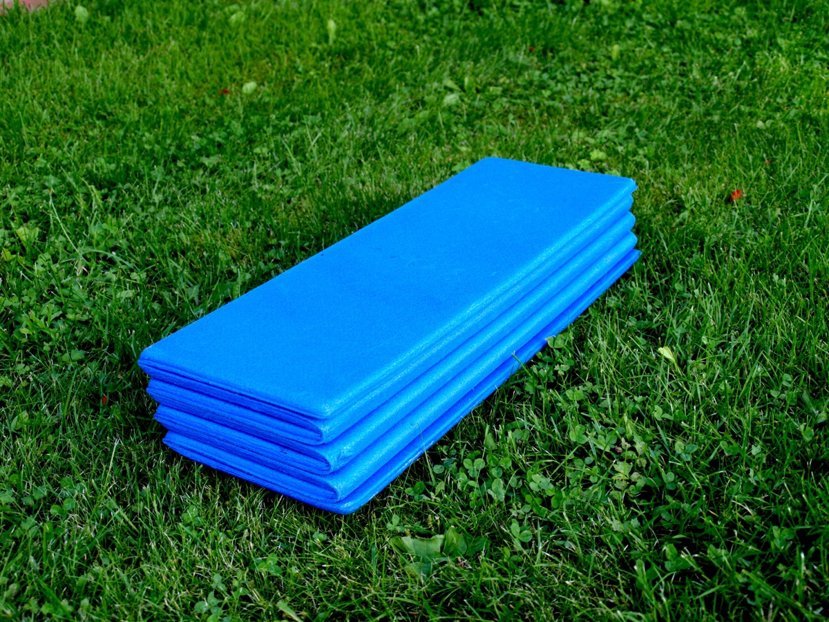 A rolled-up blue exercise mat