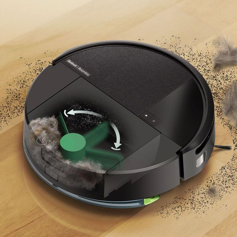 A robot vacuum cleaning near a wall in a home.