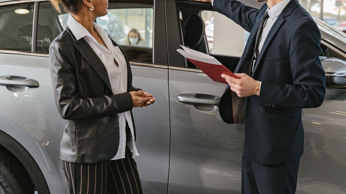 A salesperson showing a car to a customer