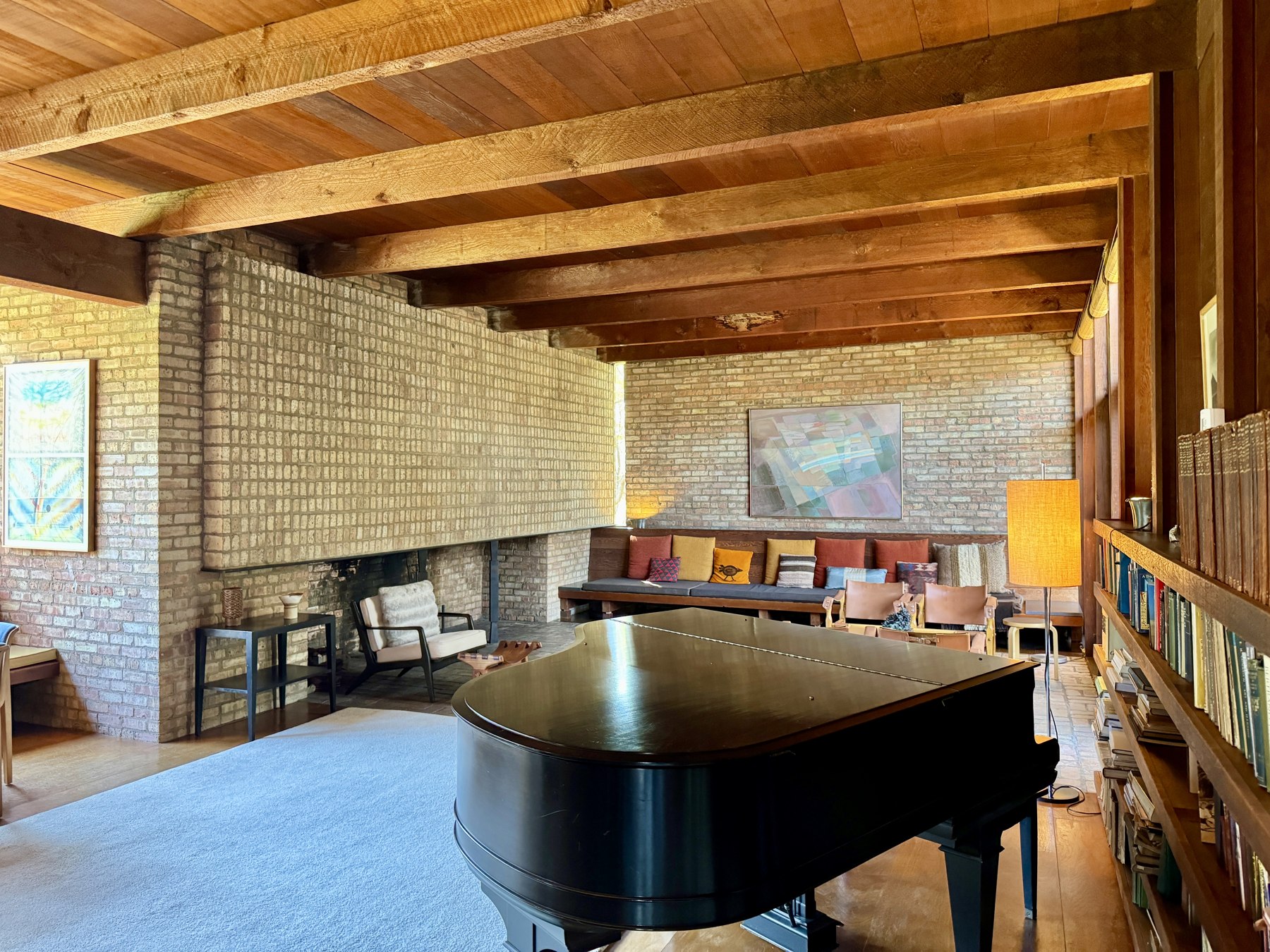 A real, architect-designed mid-century living room with layered lighting and mixed materials