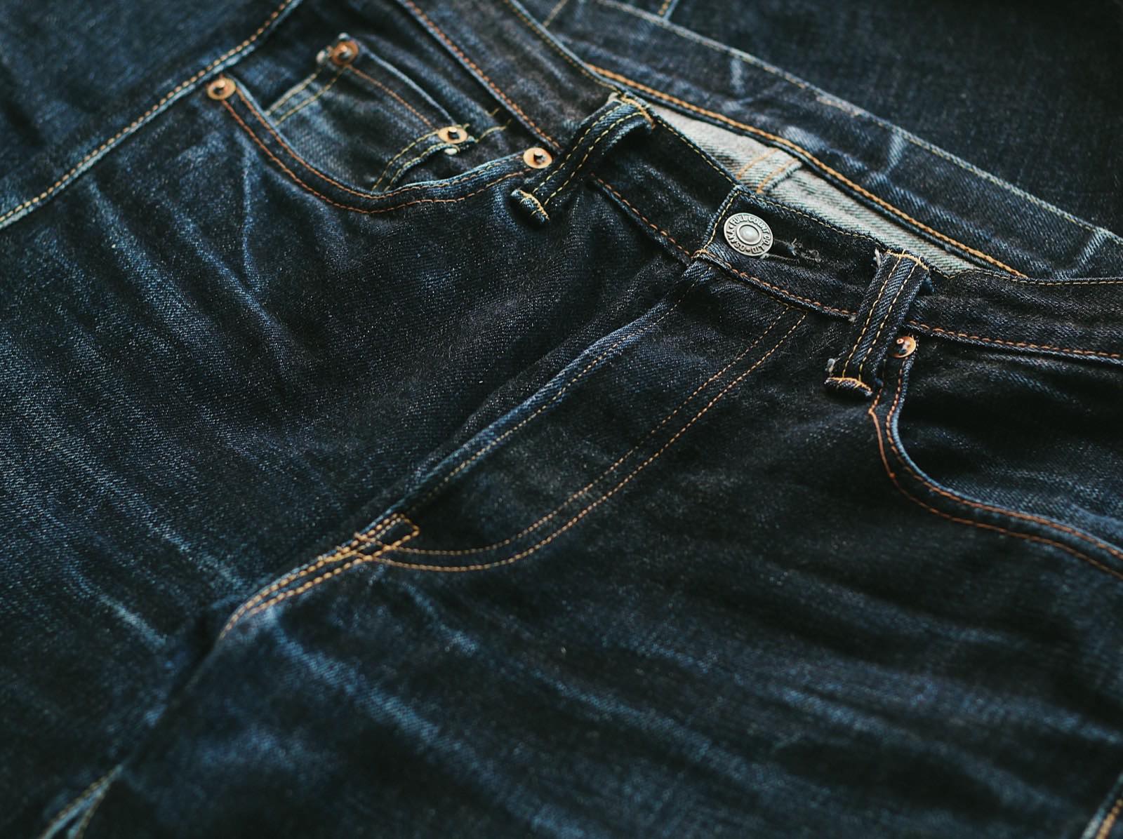 Close-up of raw selvedge denim fabric, a real photograph of woven textile.