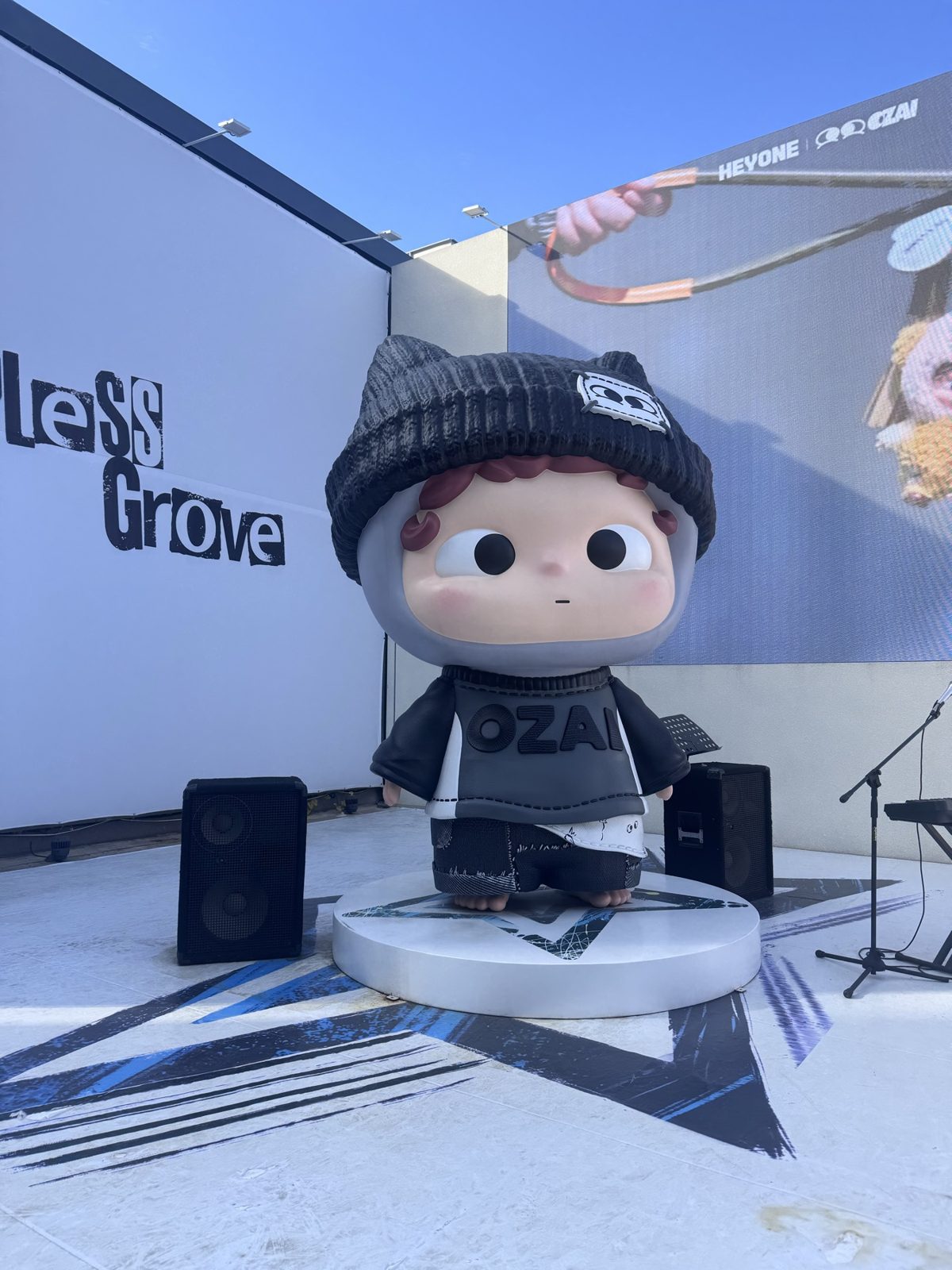 A giant cartoon character figure in a knit hat, installed outdoors in Seongsu.