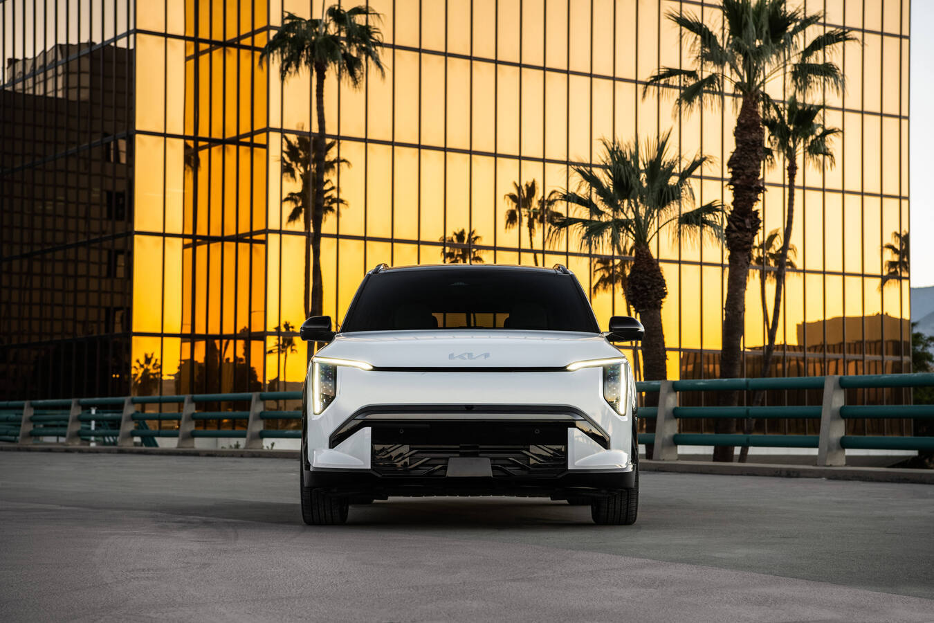 2027 Kia EV3 front view parked on a rooftop at sunset, official Kia press photography.