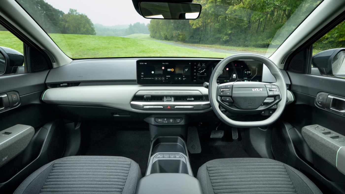 Kia EV4 interior, wide dashboard view showing dual displays, official Kia press photography, road test.