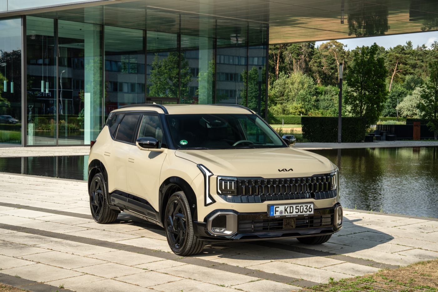 2027 Kia Seltos X-Line AWD three-quarter front view, tan exterior, official Kia press photography.
