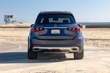Rear view of the Mercedes-Benz GLS on a beach road.