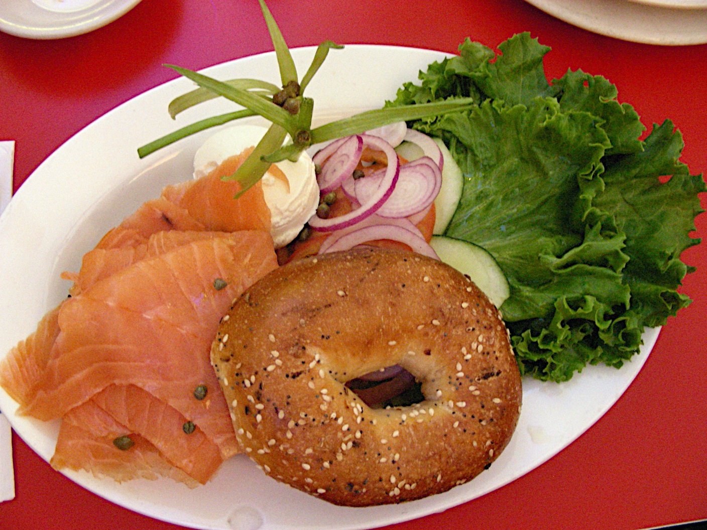 A bagel with lox and cream cheese, a real photograph.
