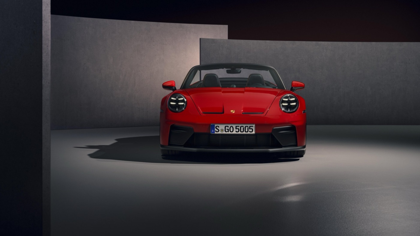 A red Porsche 911 GT3 S/C photographed head-on in a studio setting.