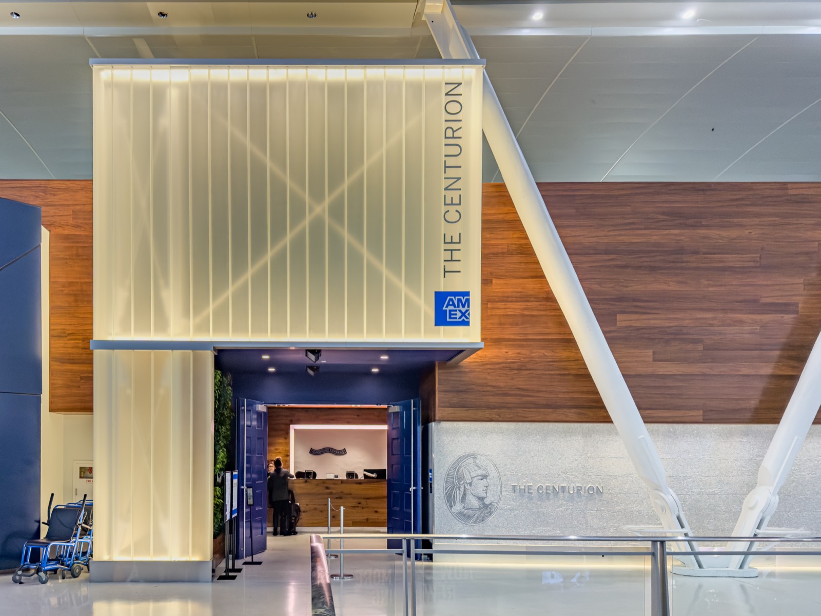 The Centurion Lounge entrance at JFK Terminal 4, marked with the American Express logo, a real photograph.