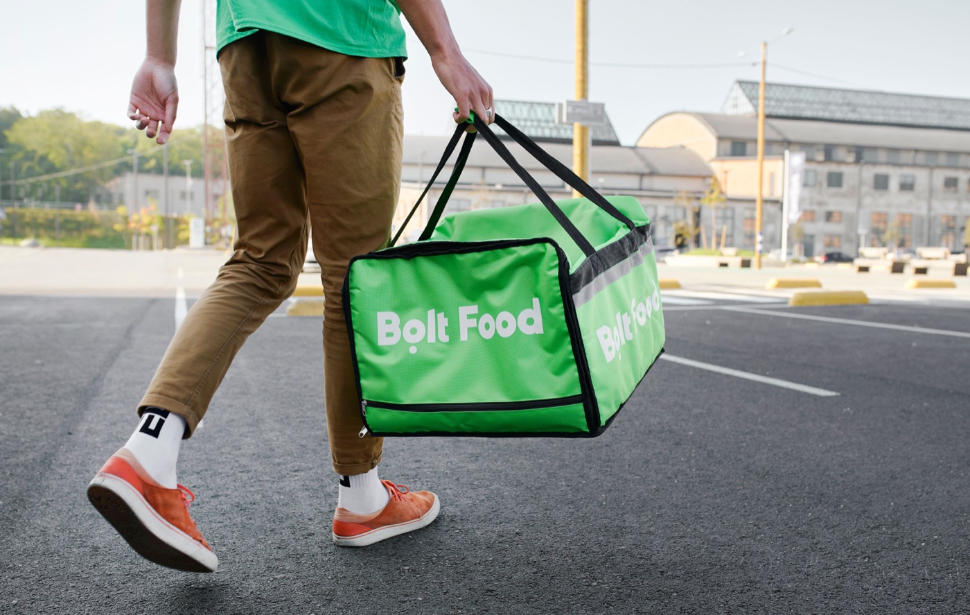 Food delivery courier with delivery bag, a real photograph