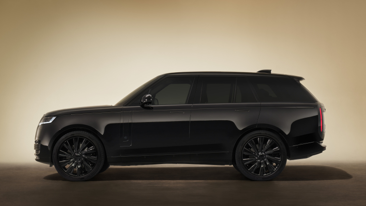 Range Rover SV in a dark studio setting, side profile.