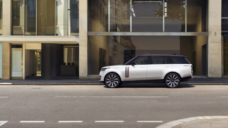 Range Rover SV long-wheelbase, side profile, parked on a city street.