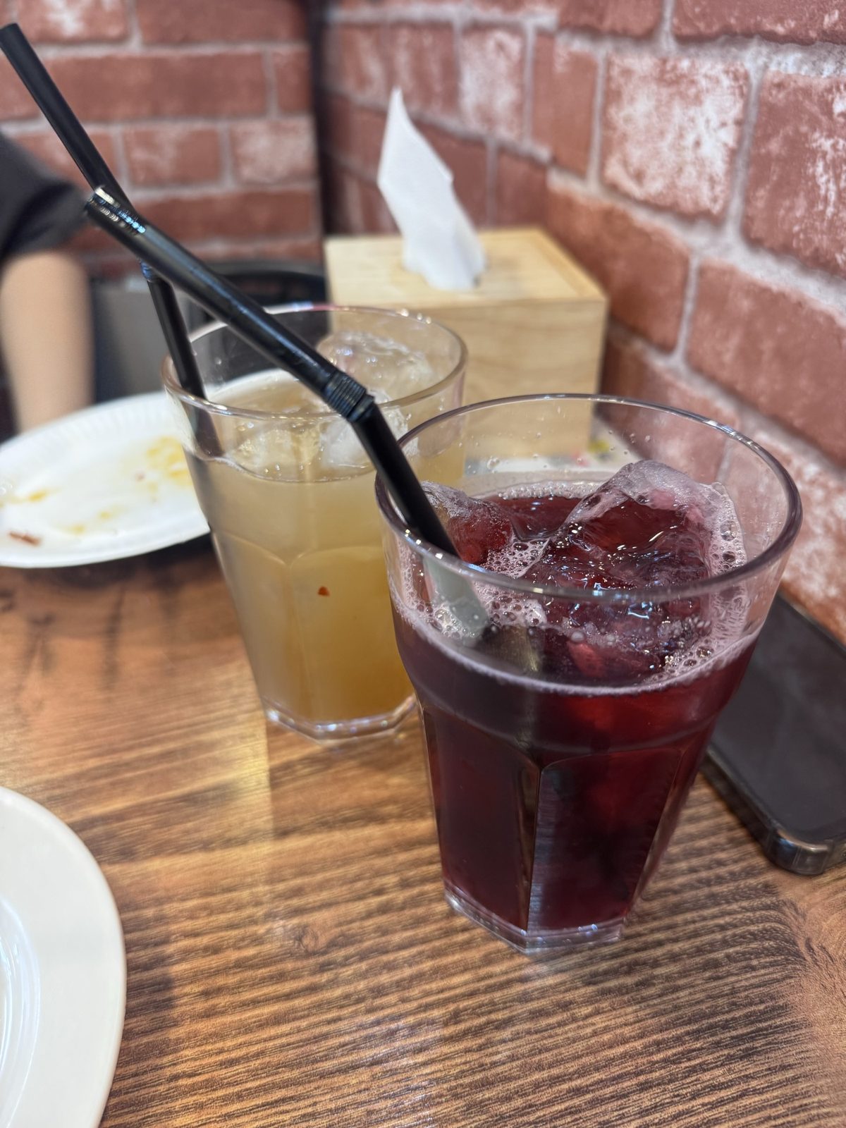 Two aguas frescas at Taco La Mexicana: a pale tamarindo and a deep red jamaica, over ice.