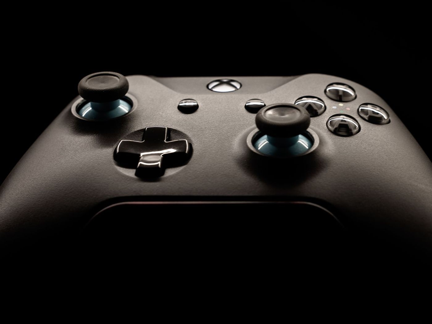 Black game controller on a dark background