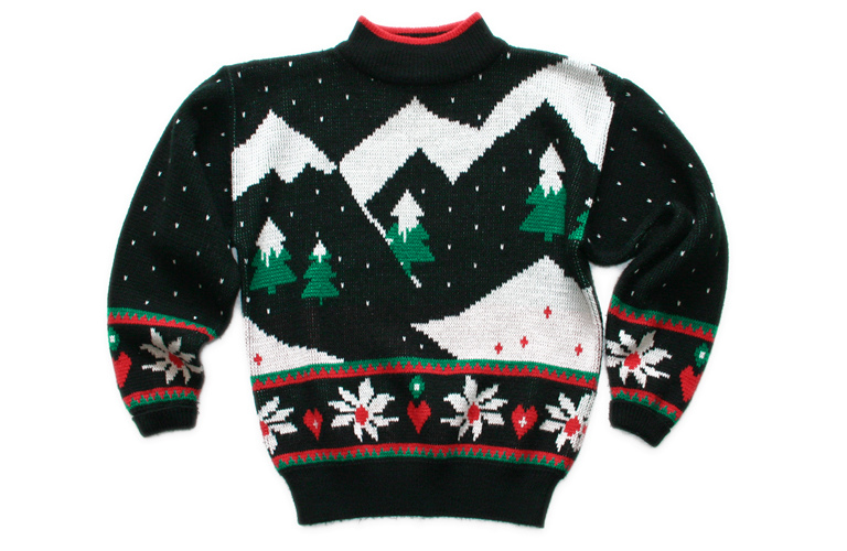A brightly colored, pattern-heavy vintage 1980s-style Christmas sweater, real photograph.