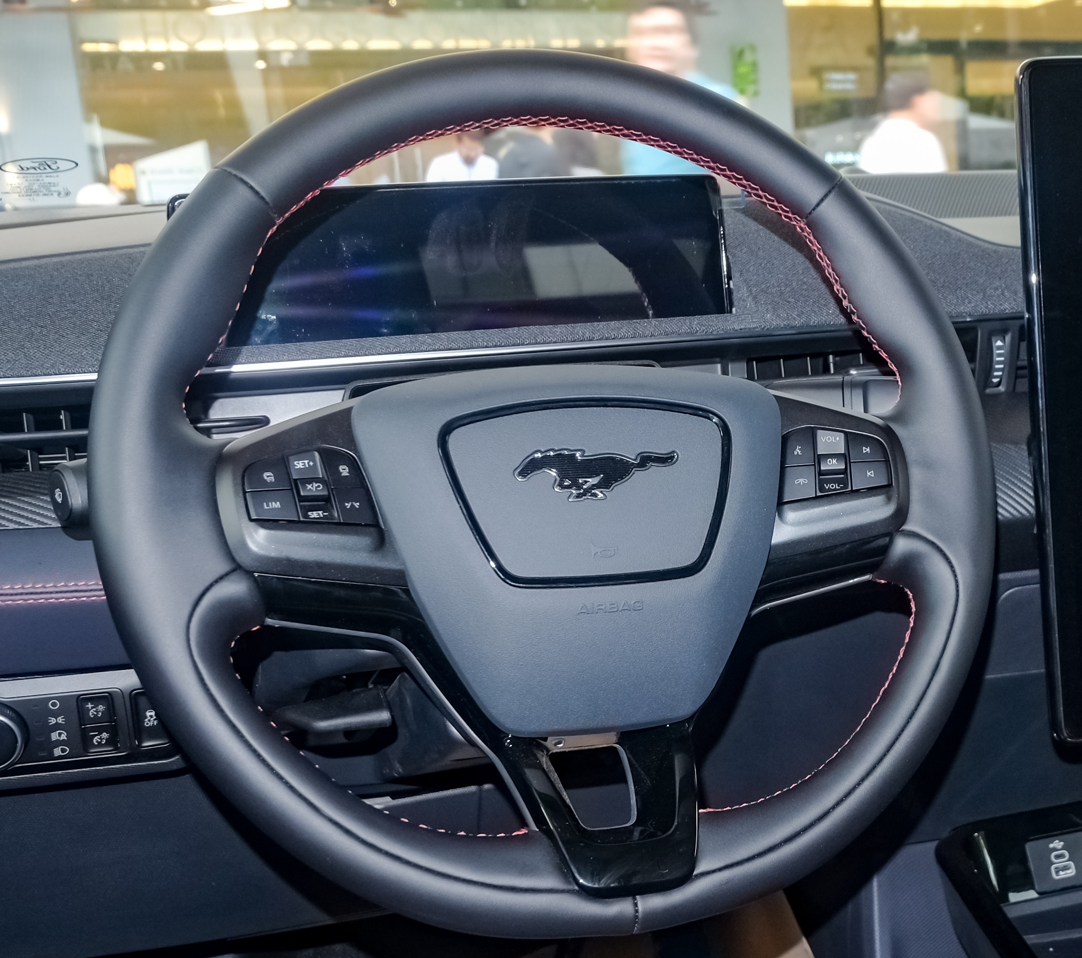 Ford Mustang Mach-E steering wheel closeup with capacitive controls.