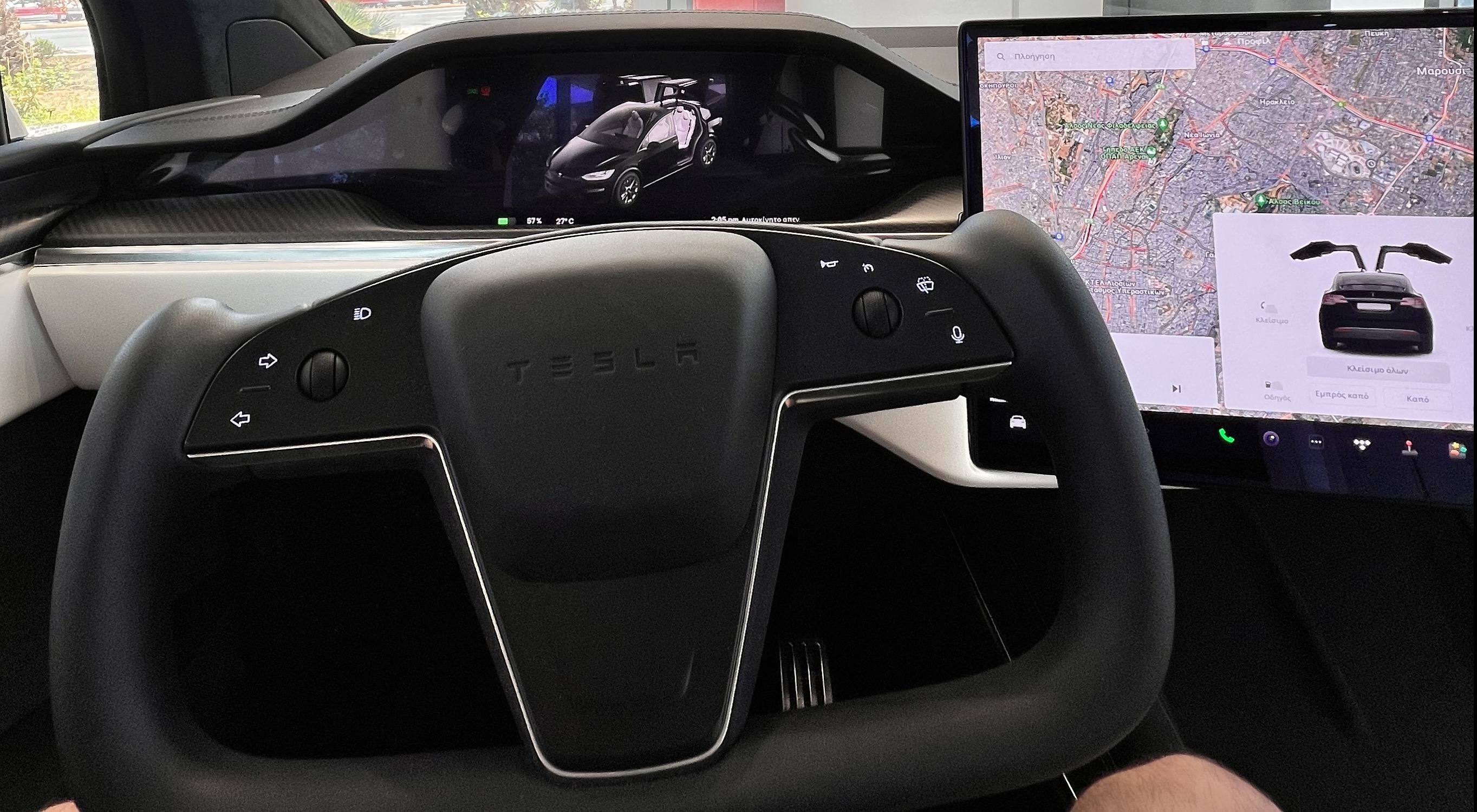 Tesla yoke steering wheel closeup showing touch-sensitive controls.