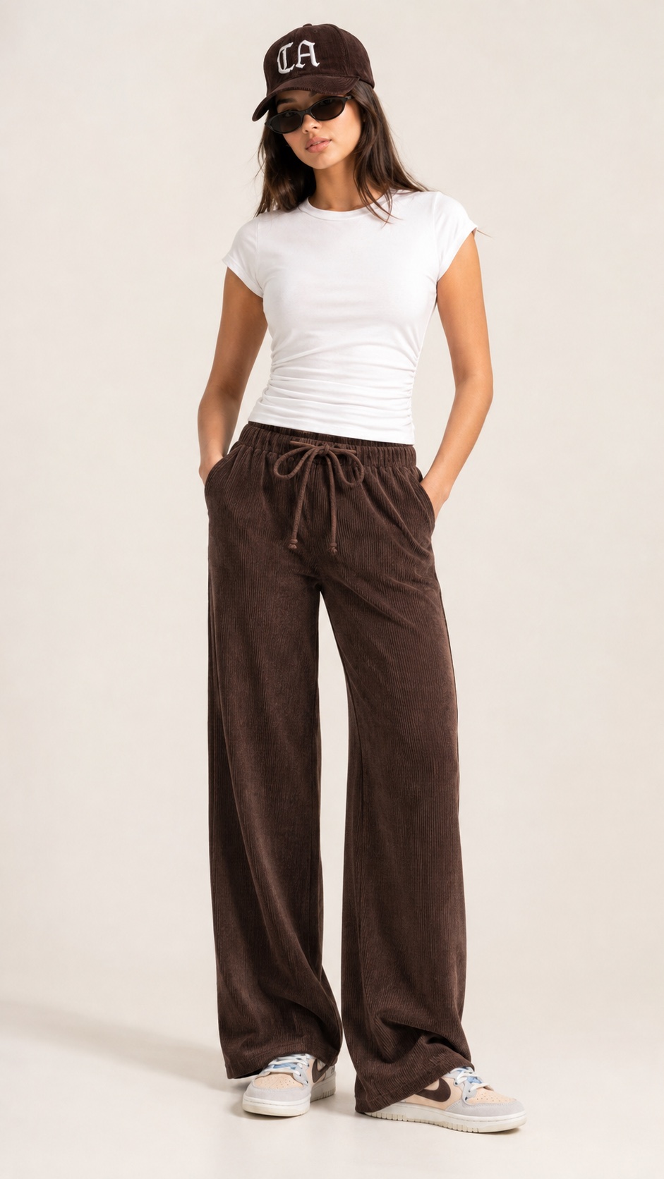Outfit with White ruched sleeveless crop tank top, Brown ribbed wide-leg drawstring pants, Dark brown ca embroidered baseball cap curated by @LAdopasnap
