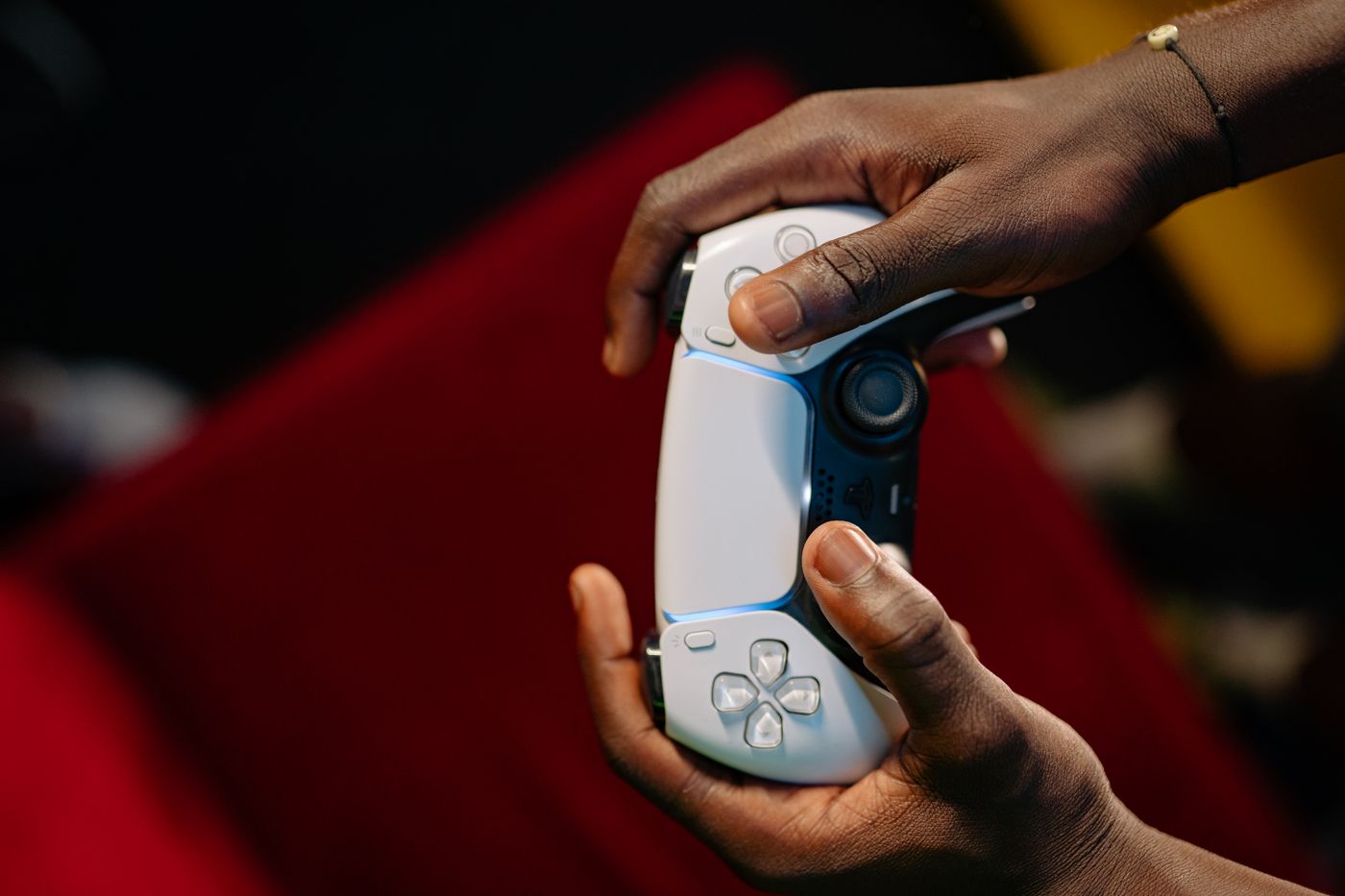 Hands holding a wireless video-game controller.