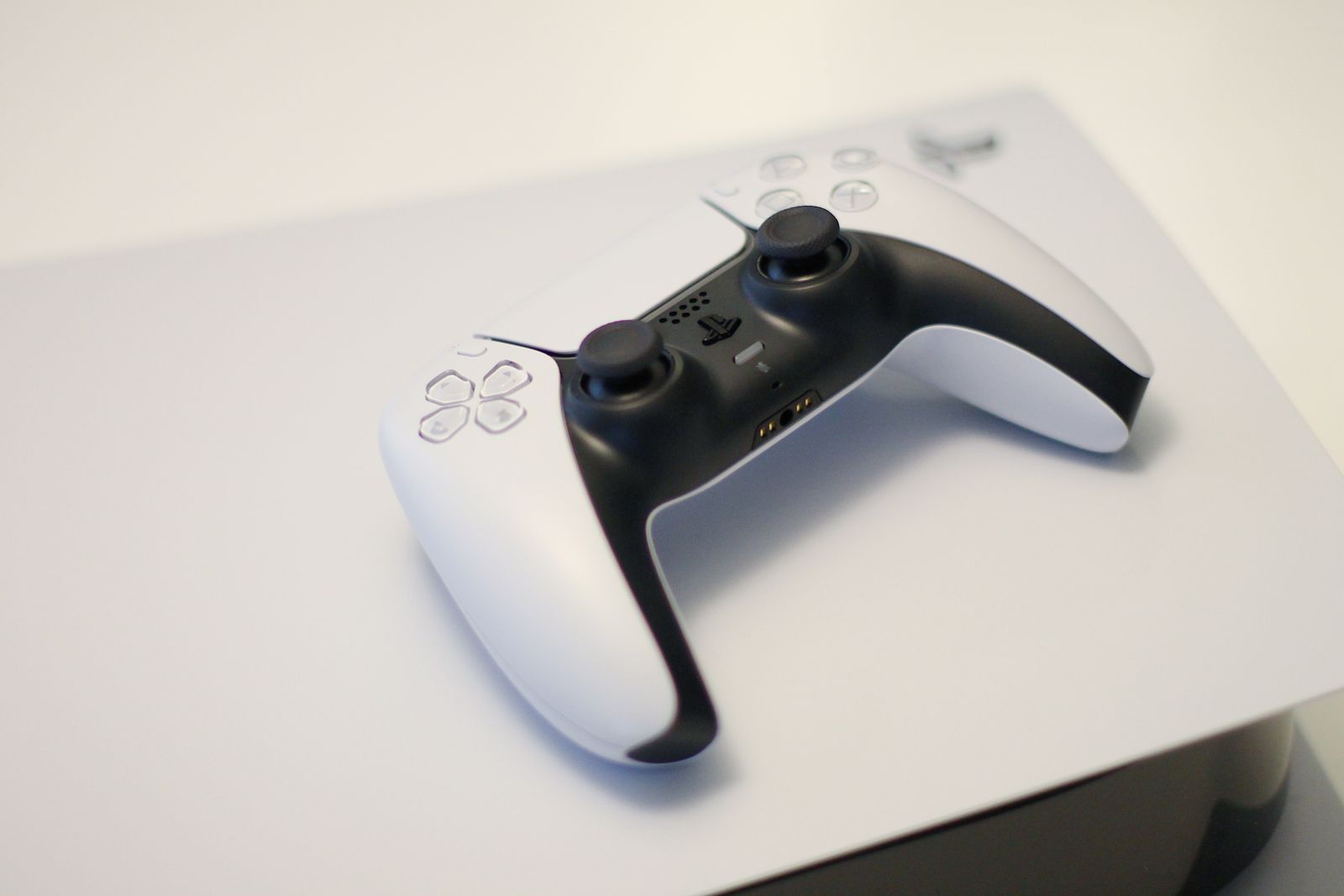 PlayStation-style game controller resting on a console.